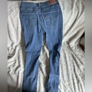 Levi’s medium blue Jean with rips in the knees